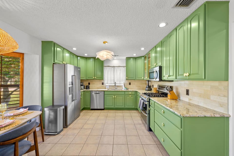 Green cabinets, golden moments! Bold, bright, and ready for your signature dish (or takeout).