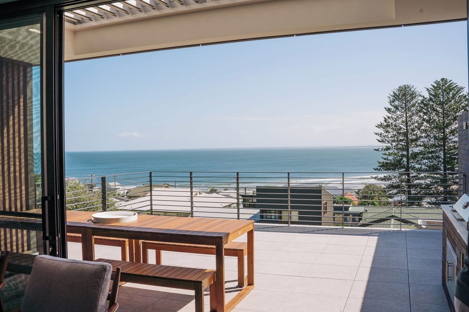 The main living area flows onto a large balcony for alfresco dining.