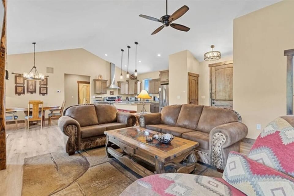 Bright, open-concept living room with vaulted ceilings, high-end furnishings, and tons of natural light—designed for cozy gatherings and mountain views.