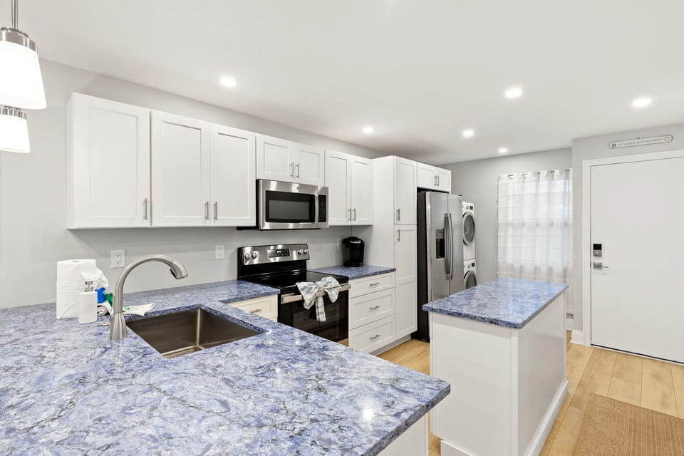 Open Kitchen with Stone Counter Tops and Stainless Appliances
