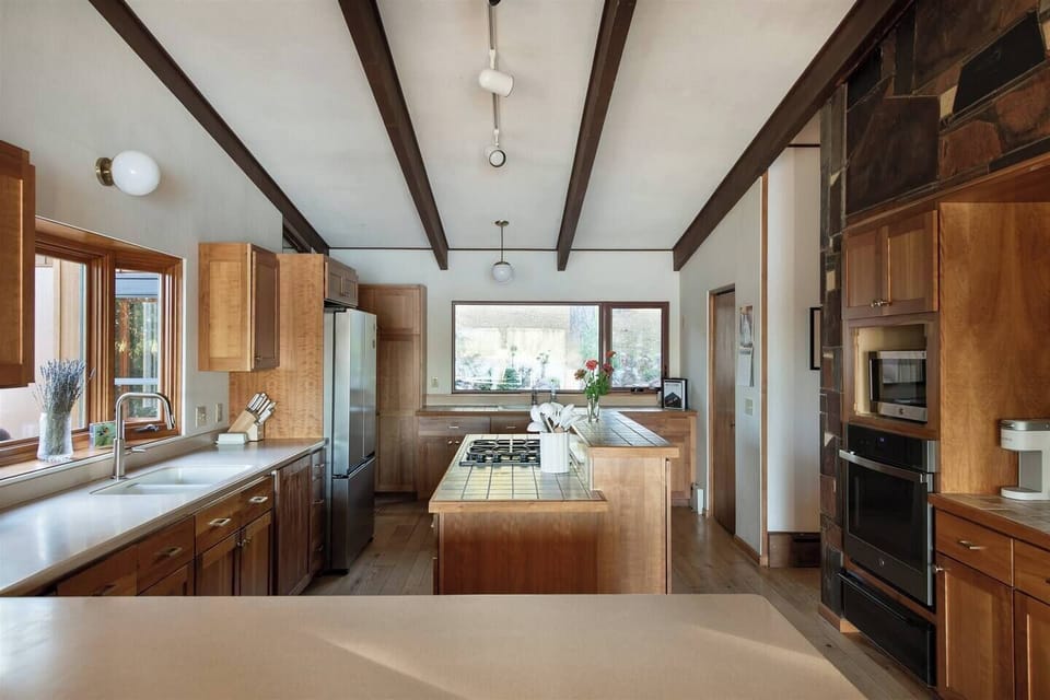 A warm, modern kitchen blending mid-century design with everyday convenience.