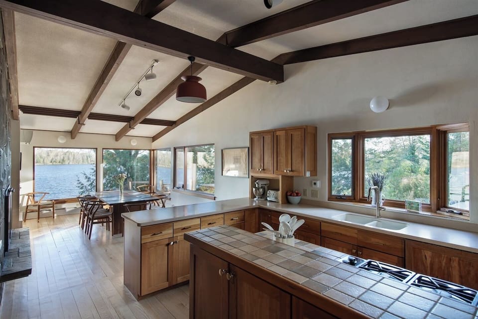 Cook with panoramic lake views in a fully stocked, design-forward kitchen.