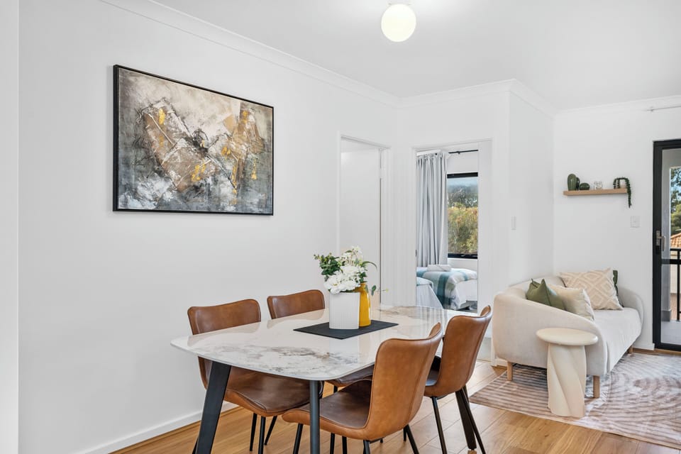 Contemporary dining space with a statement table and chairs, perfect for shared meals, remote work, or morning coffees.