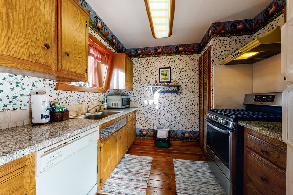 Fully equipped cabin kitchen with ample cabinetry, stove, fridge, microwave, and coffee maker—perfect for cooking meals, morning coffee, and feeling right at home on your stay.