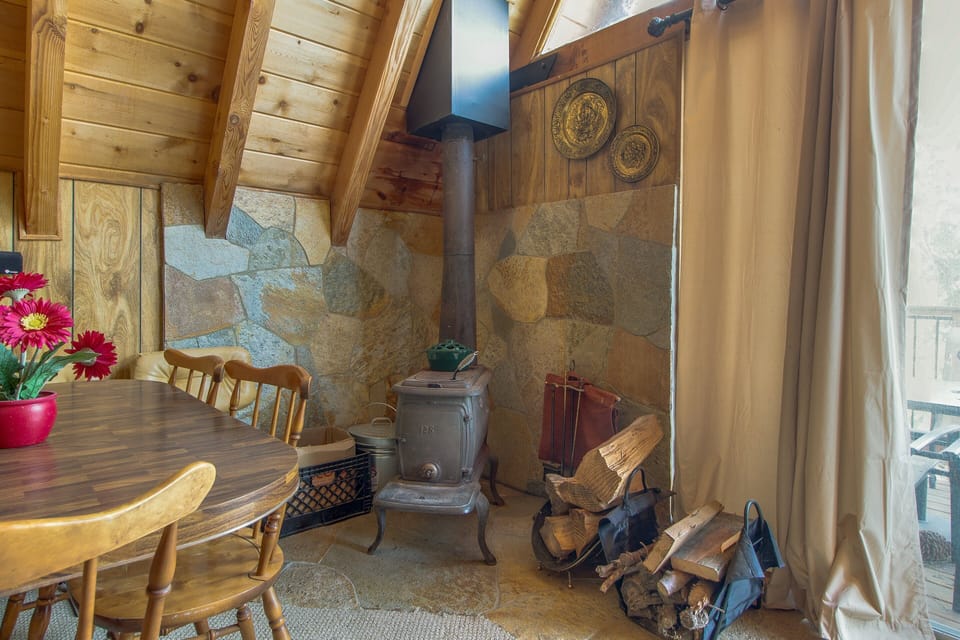 Stay warm and cozy by the charming wood-burning stove, perfect for snowy evenings and relaxing nights after a day of mountain adventures.