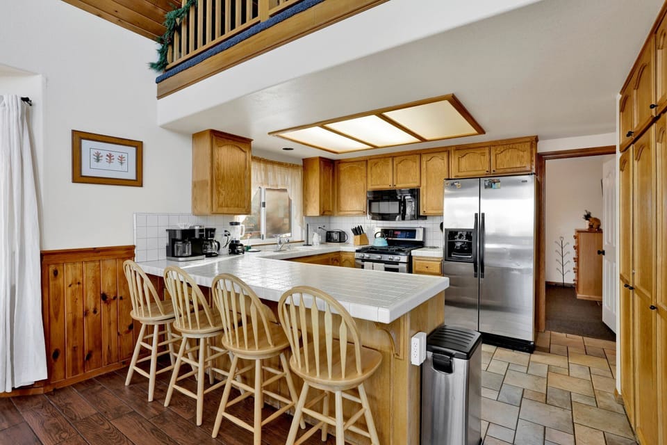 Gather and enjoy meals together in the fully equipped kitchen and dining area, featuring a dining table with seating for up to 8.