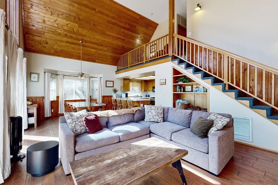 The living and family room offers cozy seating and a TV, creating a comfortable space for movie nights, games, and quality time with your group.