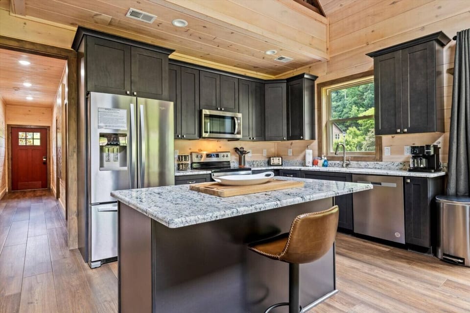 The spacious island with bar seating is ideal for quick breakfasts, casual conversations, or serving up a family feast.
