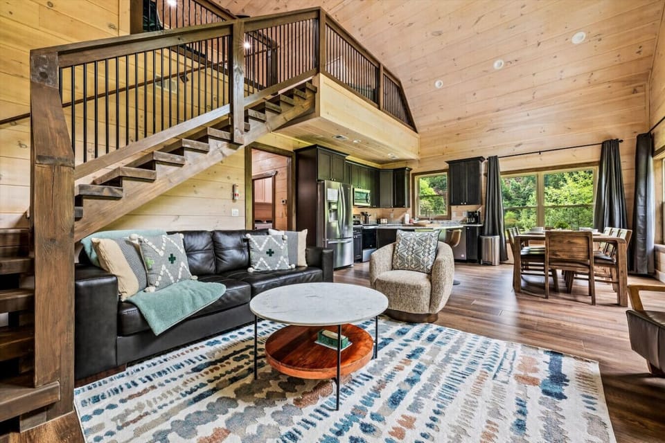 Vaulted ceilings and warm wood tones make this living space feel both open and cozy, with plush furniture offering a comfortable spot to relax after exploring the Smoky Mountains.