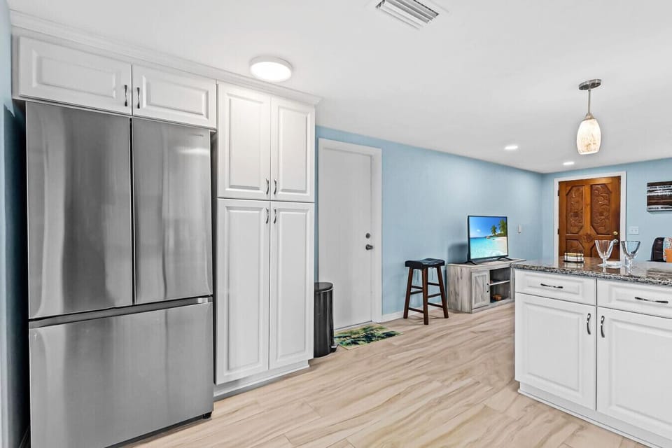 Spacious kitchen with a French-door fridge and plenty of storage for groceries, drinks, and beach snacks.