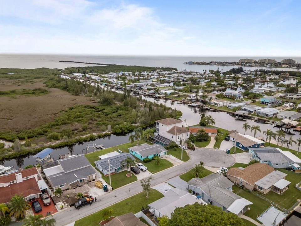 Just beyond the canal, lush greenery gives way to Florida’s sparkling coastline, a reminder that the Gulf is only moments away.