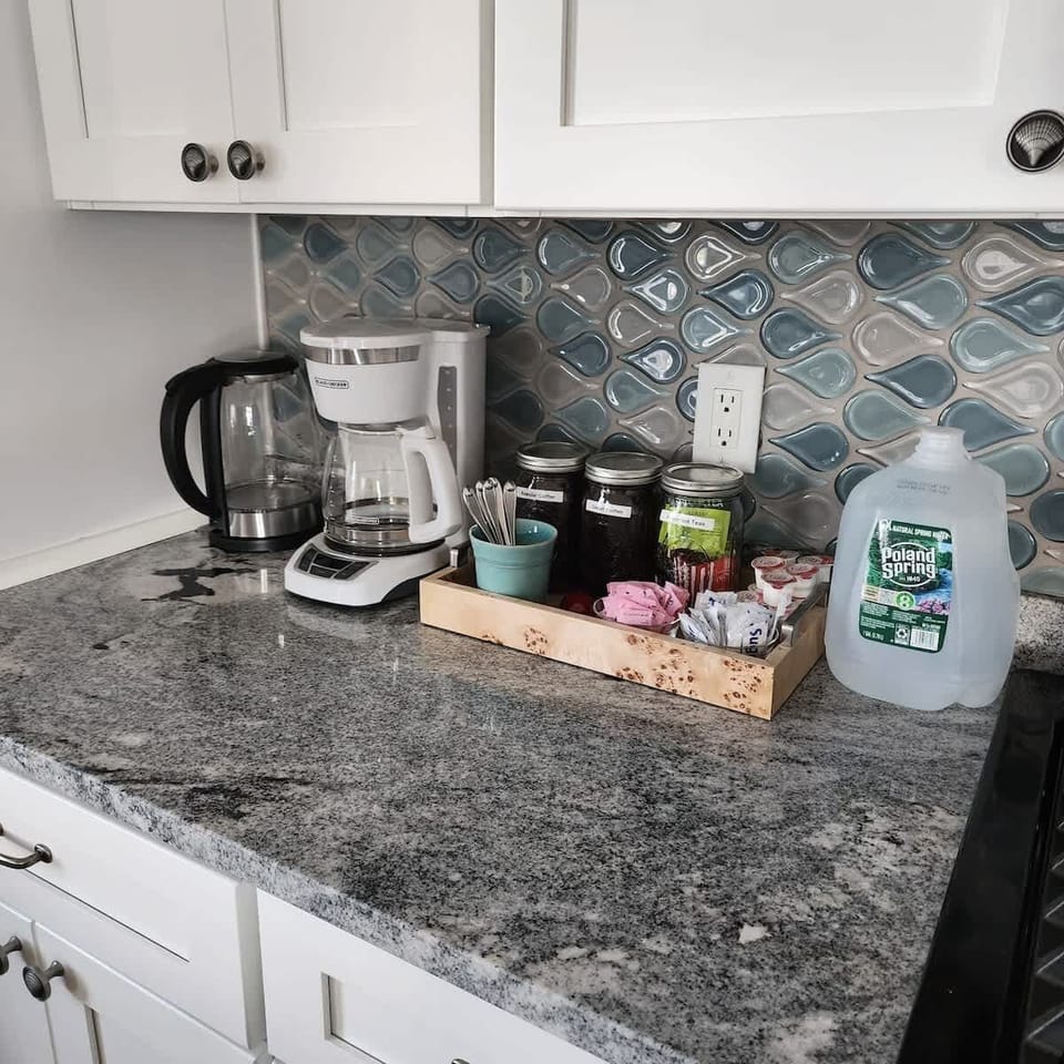 Brew, sip, and savor: Our fully equipped coffee station features a coffee pot, electric tea kettle, coffee, tea, spring water, creamers, sweeteners, and more, ensuring a perfect cup every time.