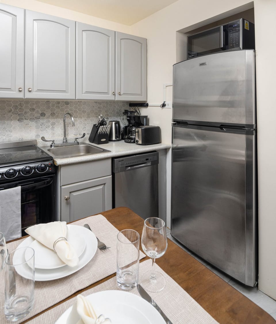 Modern kitchen with full amenities and cozy dining.
