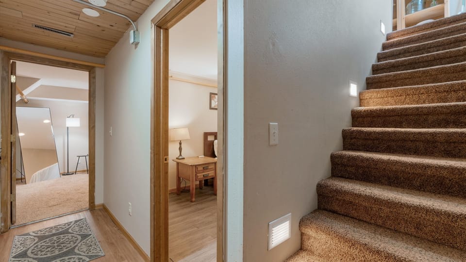 The bedrooms are down the stairs from the kitchen.