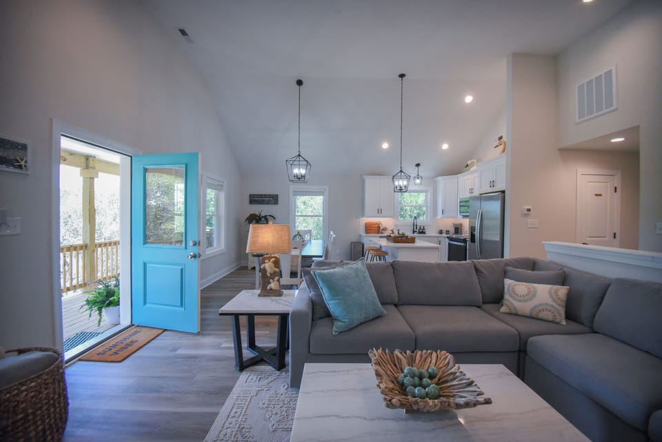 Living Room - comfortable seating, smart TV, books, games, and puzzles.