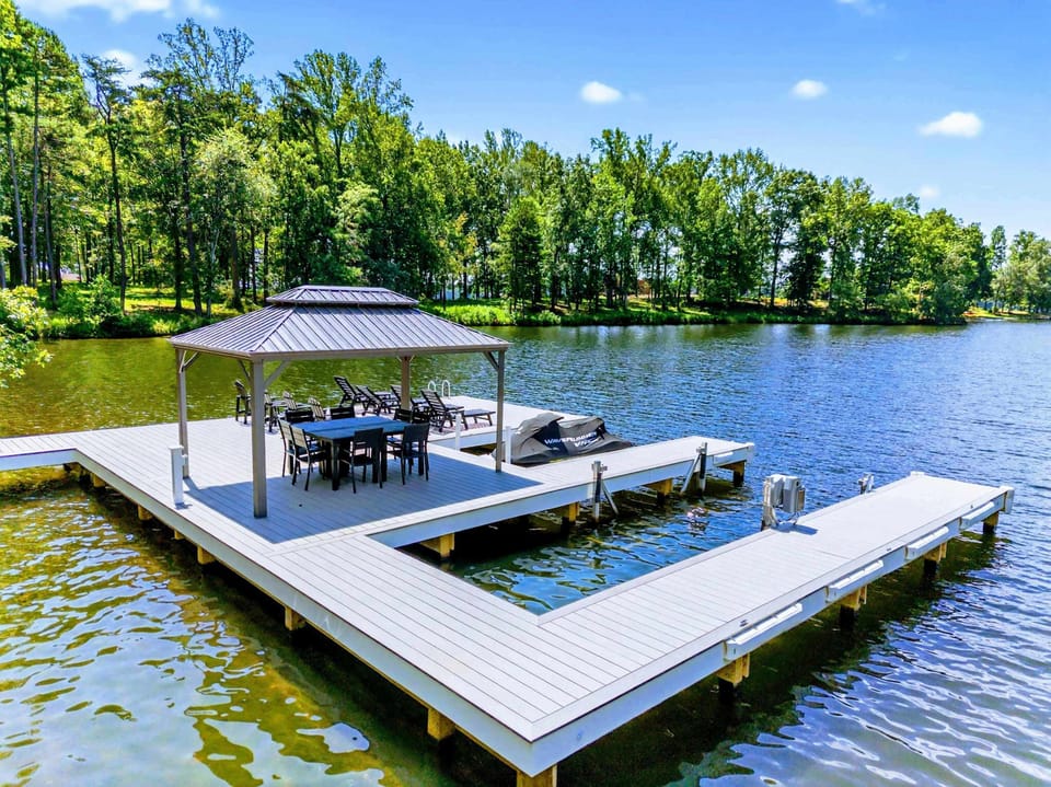 Sandy Beach - Private sandy beach area with Adirondack seating at the water's edge.
