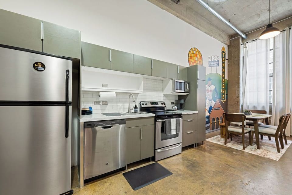 Fully equipped kitchen with electric stove/oven, dishwasher, and refrigerator.