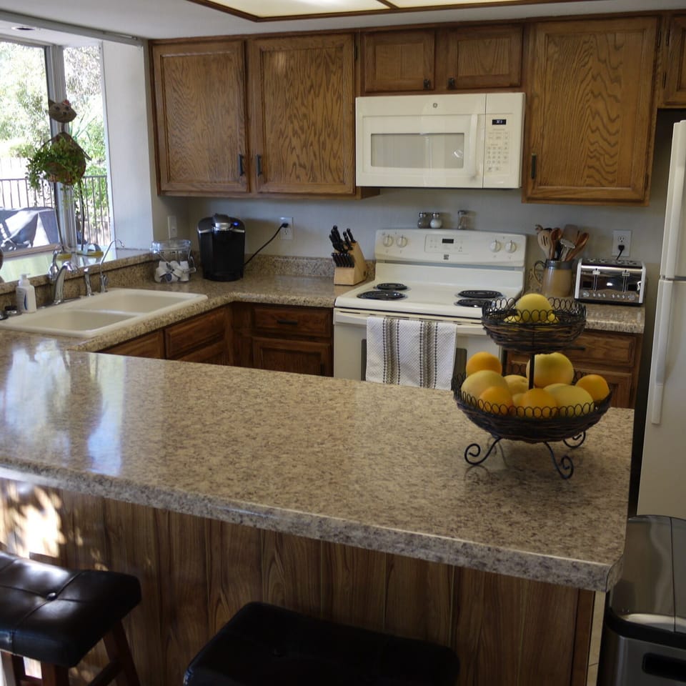 Dining room looking to kitchen with counter dining area