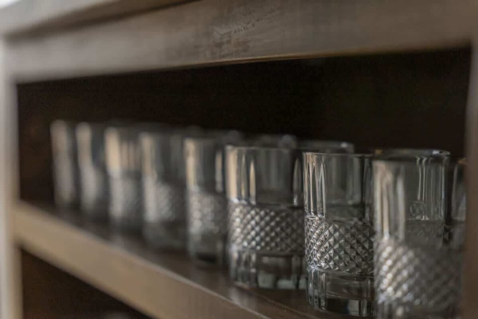 Shelf stocked w/ glassware, ready for mixing drinks or evening cocktails