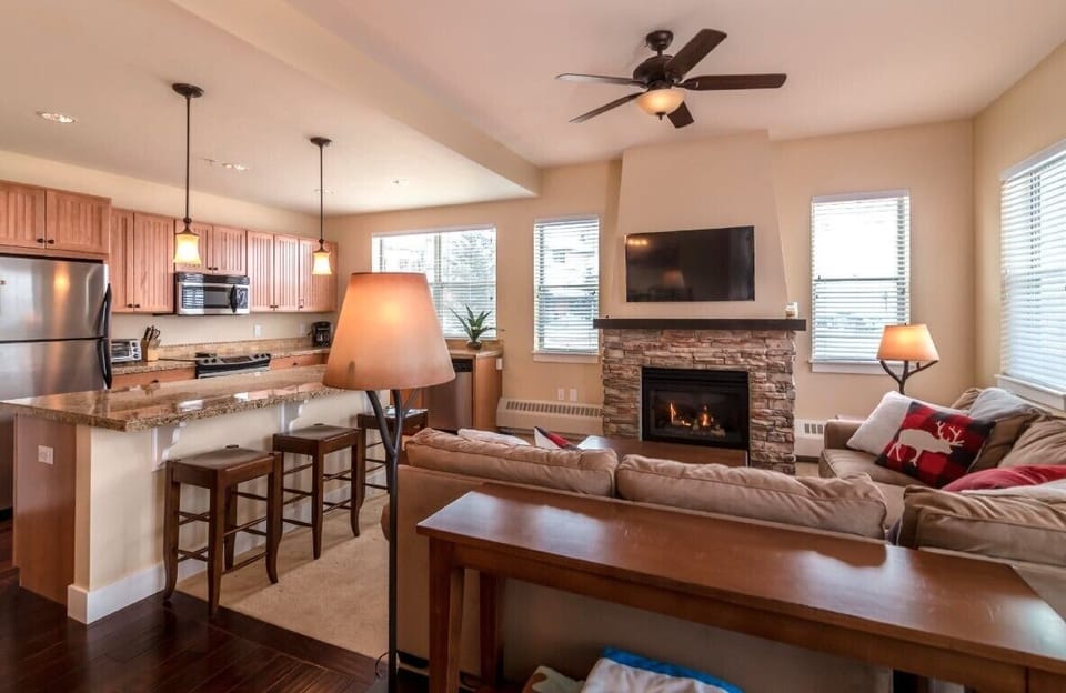 Spacious living room with kitchen counter seating. 