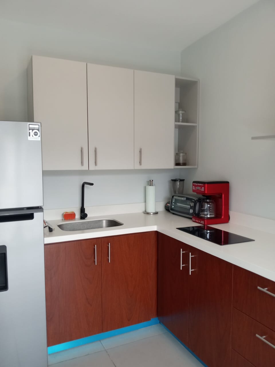 With stainless, water dispensing fridge, mircowave, toaster.