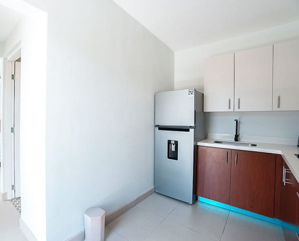 Dishes, cutlery, blender, toaster oven, cooking utensils, coffee maker.