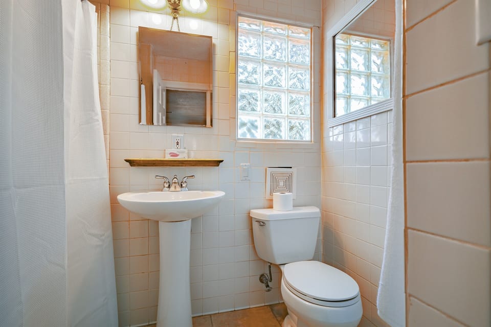 The sleek, modern bathroom offers a bright and peaceful space to start or end your day with ease.