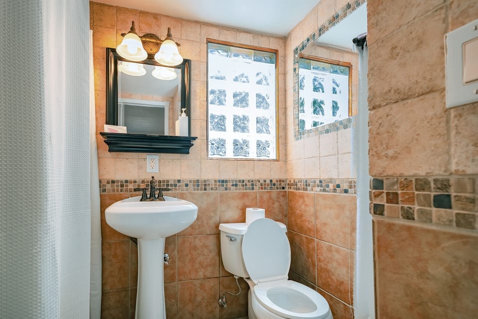Bright and modern, the bathroom is a serene space for refreshing starts and relaxing finishes.