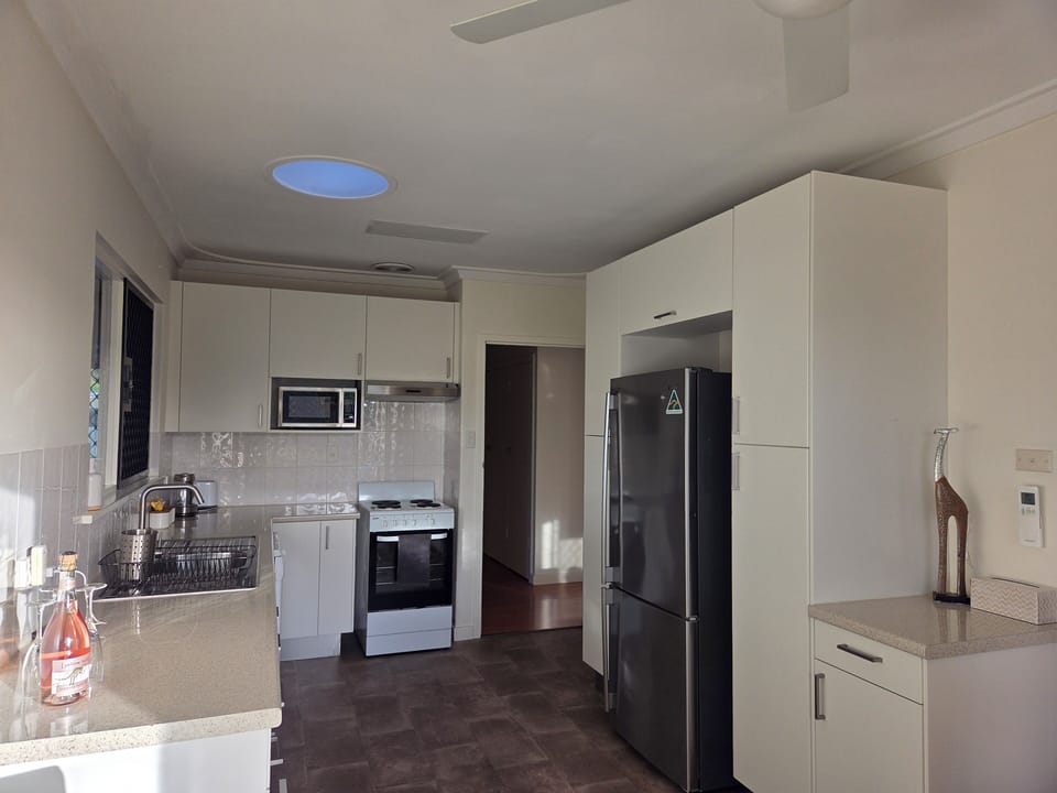 Fully equipped kitchen with large fridge and freezer.