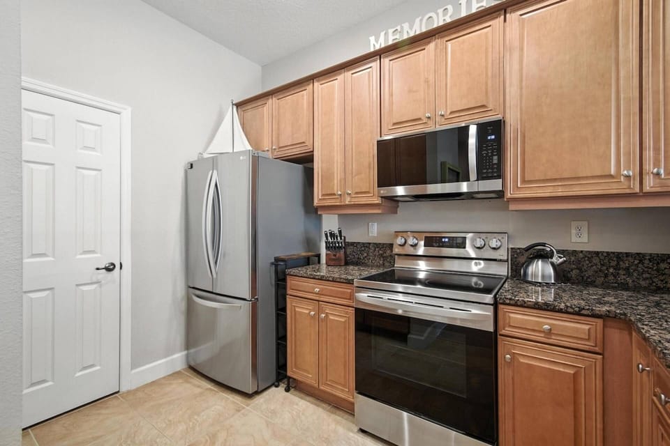 Spacious kitchen featuring stainless steel appliances and an airy open-concept design.