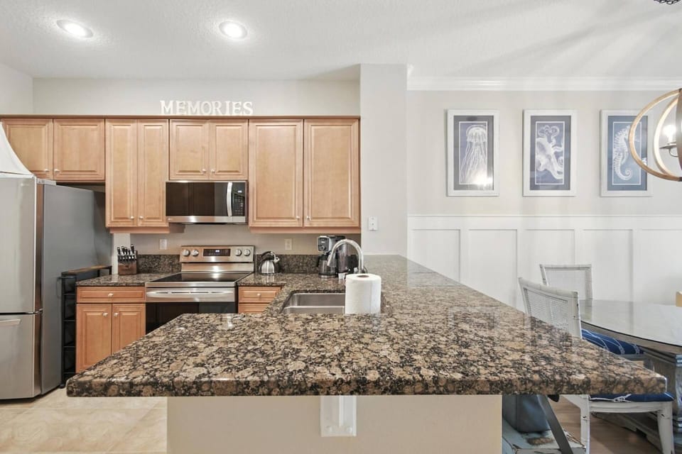Spacious kitchen featuring stainless steel appliances and an airy open-concept design.