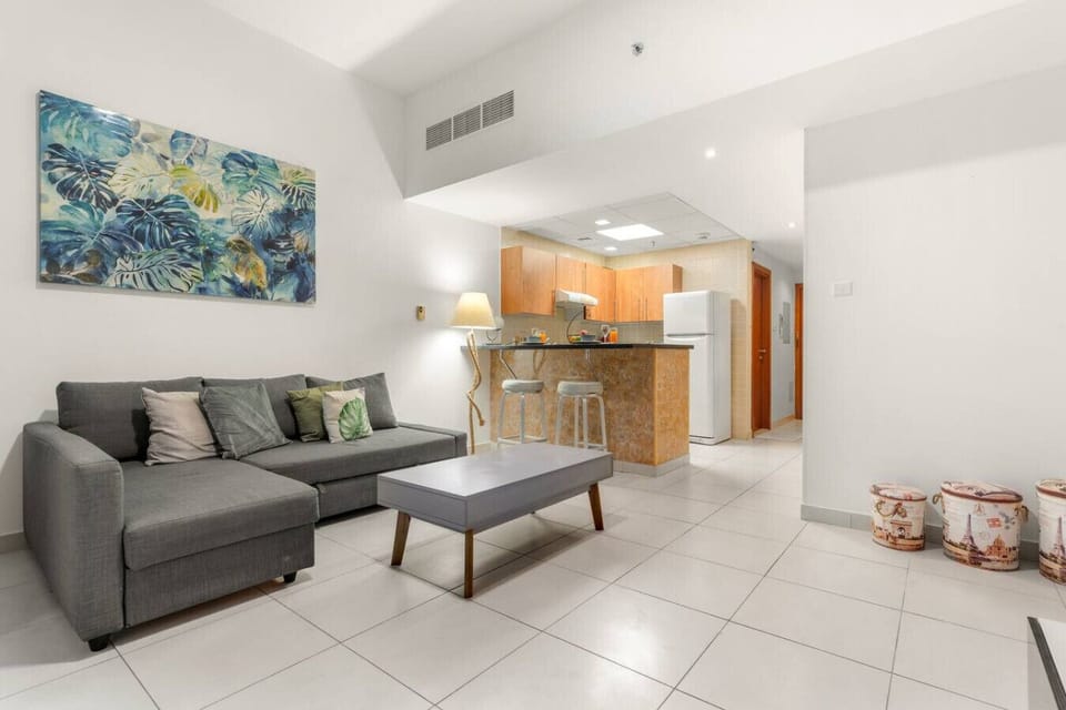 Living Room: Bright and inviting space with modern decor and a sleek kitchen backdrop!