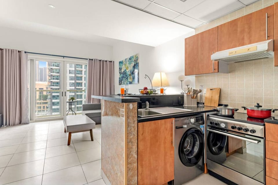 Modern Kitchen & Living Area: Bright, stylish space with city views, perfect for culinary adventures!