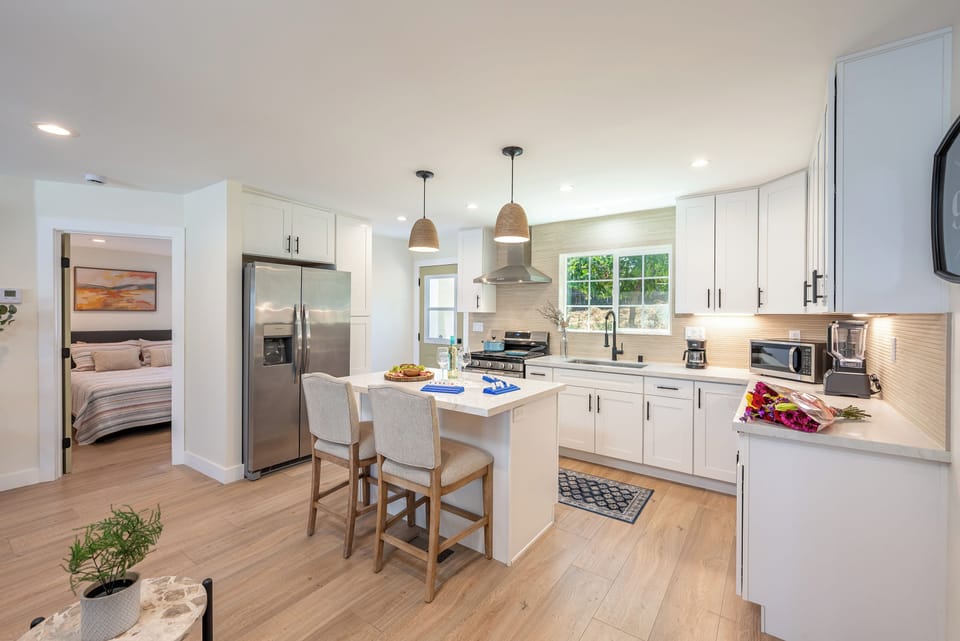 Modern kitchen with stainless steel appliances and ample cabinet storage.