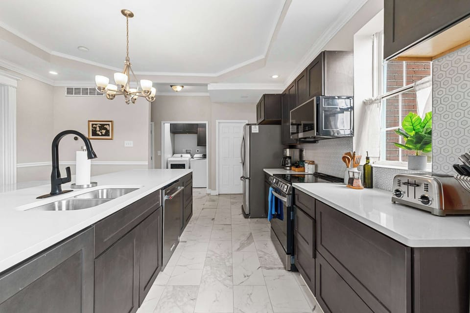 Welcome to your new favorite gathering spot! Whether you're whipping up a cozy breakfast or hosting a dinner, this stylish kitchen is your canvas. 