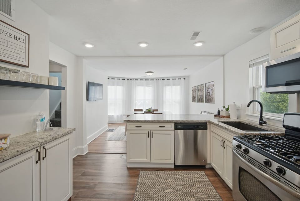 Bright and spacious kitchen opens to a dining nook and TV area—great for group meals, game nights, or catching up over coffee.
