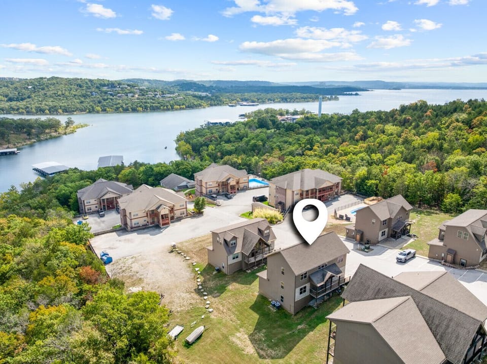Aerial view of the cabin showing how close you are to the lake — an ideal spot for families to relax, explore, and make memories.