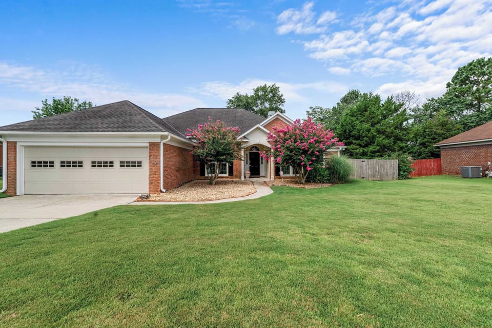 A warm welcome awaits with a spacious, inviting front yard.