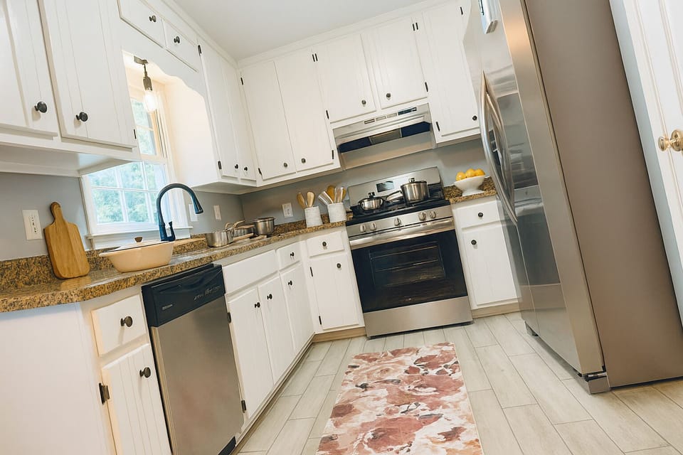 Bright chef-ready kitchen with stainless appliances and stone counters