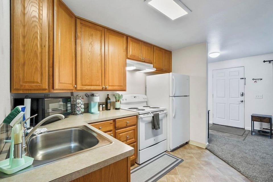 Well stocked kitchen with full size stove with oven and fridge. 