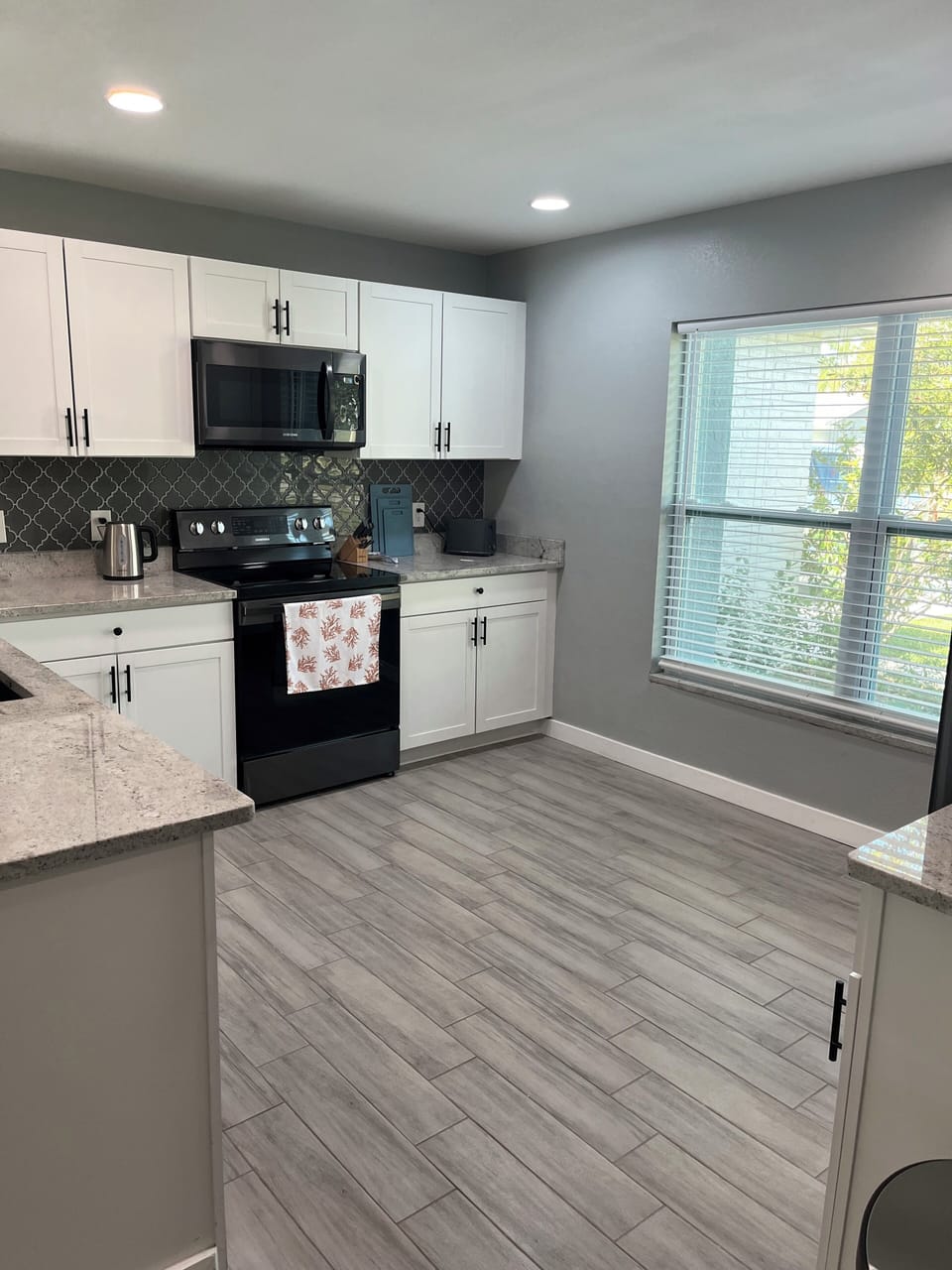 Kitchen equipped with crock pot, Keurig, blender, toaster cookware & dinnerware.