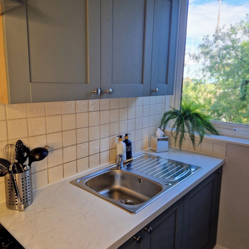 spacious kitchen, coffee machine, fridge, microwave, stove, toaster, oven