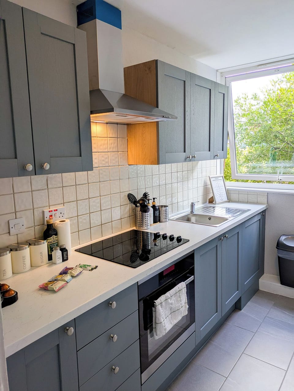 spacious kitchen, coffee machine, fridge, microwave, stove, toaster, oven