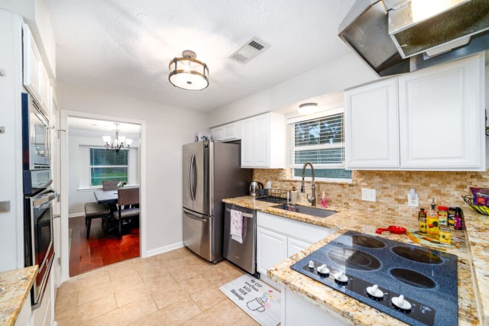 right, fully stocked kitchen with modern appliances and a welcoming view into the dining room.
