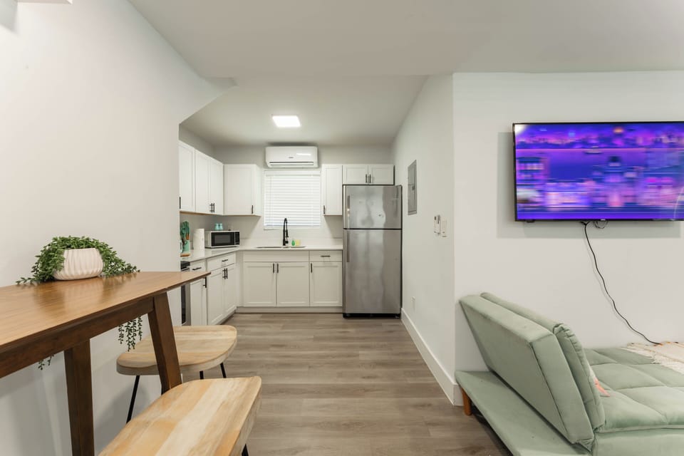 Open kitchen with dining bar, stainless appliances, and plenty of counter space.