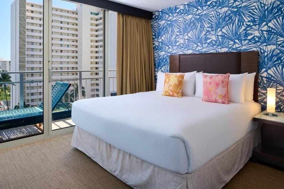 Drift off in crisp linens beside your private balcony view.