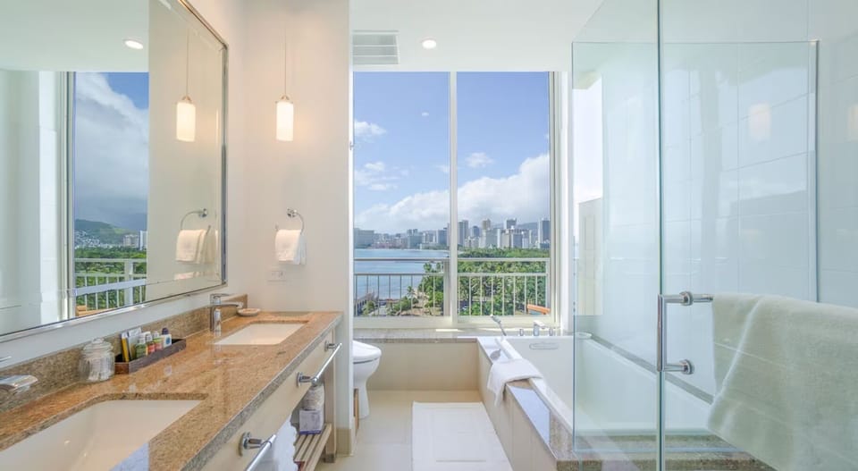 Refresh in a spa-like bath with skyline-and-water views.