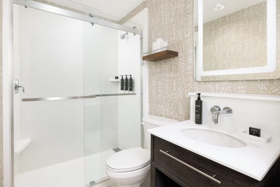 Step into a modern glass shower for a crisp rinse.