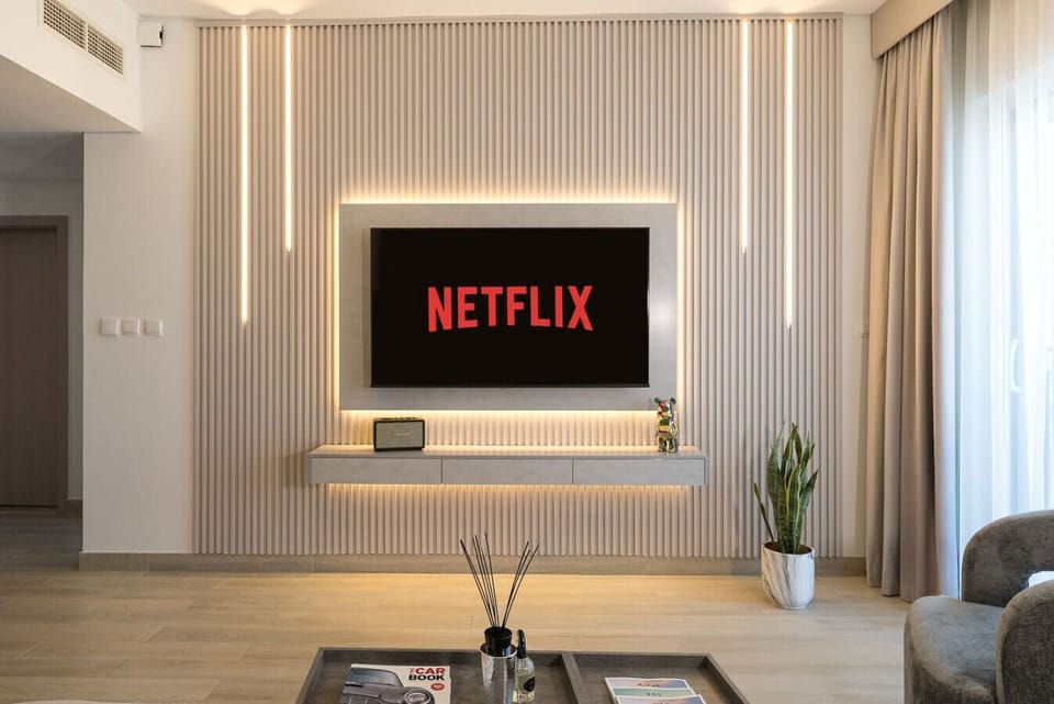 Luxury living room at Waters Edge, Yas Island, Abu Dhabi, UAE. TV wall with LED and smart TV with all features such as Netflix, Amazon Prime, Apple TV, YouTube and more.