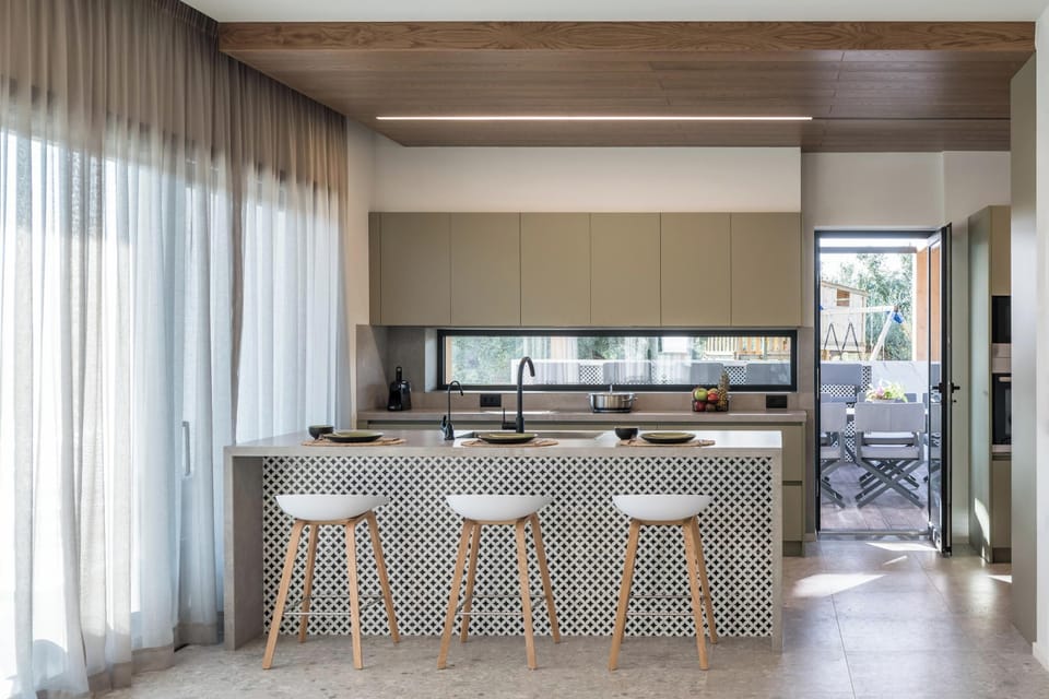 The kitchen is fully equipped with modern appliances and two wine coolers